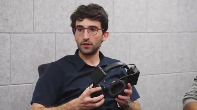 Fortell cofounder holding the early Medusa prototype: over-ear headphones with extra microphone boxes glued on
